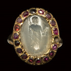 A roman chalcedony intaglio mounted on a 19th century gold ring set with garnets or spinels. Zeus.