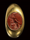 A roman red jasper intaglio set in a gold ring. Hades with Cerberus.