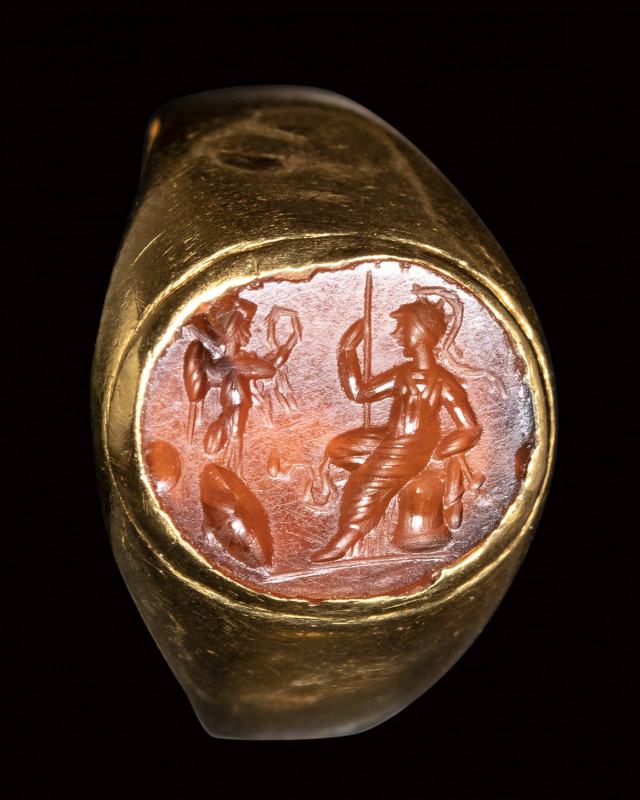 A roman carnelian intaglio set in a gold ring. Athena with Nike.

2nd century ...