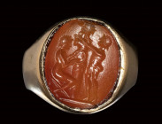 A roman carnelian intaglio mounted on a modern gold ring. Ritual scene with herm.