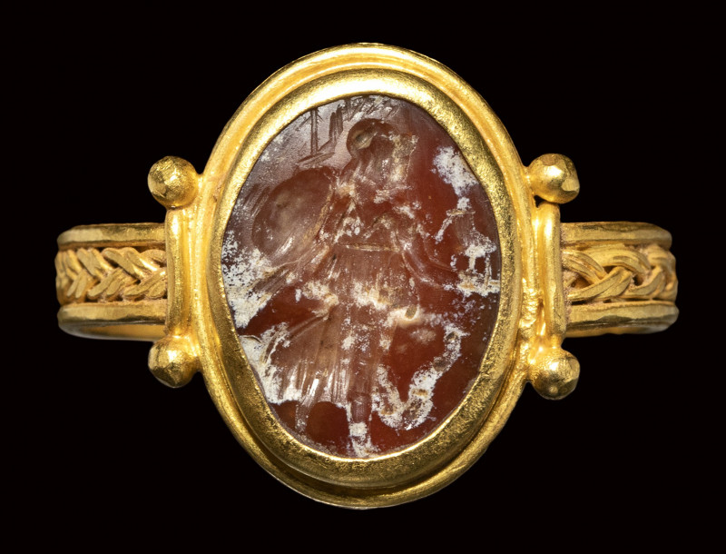 A late roman gold ring set with a burnt agate intaglio. Athena nikephora. 

3r...