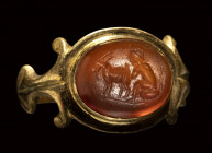 A roman carnelian intaglio set in a gold ring. Pastoral scene.