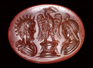 A roman carnelian intaglio. Two private portraits as Helios and Selene, with an eagle.