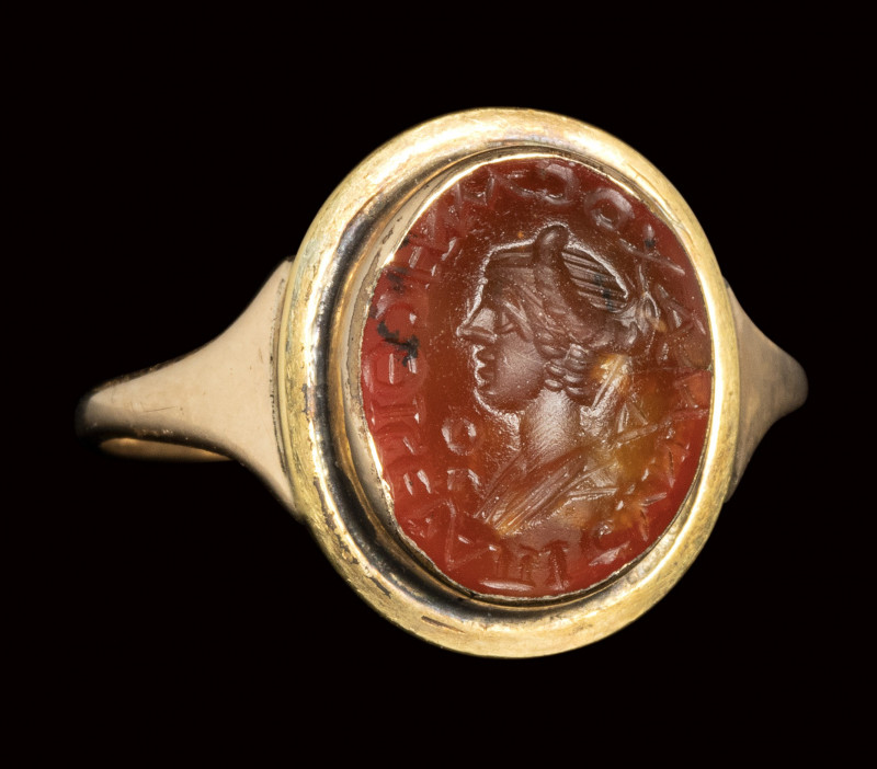 A roman carnelian intaglio set in a later gold ring. Bust of a Matrona with insc...