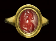 A roman carnelian intaglio set in a modern gold ring. Bust of Venus.