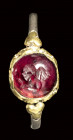 A late roman bimetallic ring with garnet cabochon intaglio. Eros.