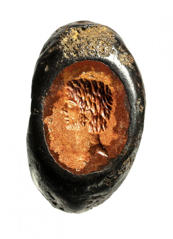 A roman imperial burnt jasper intaglio set in an iron ring. Male bust. 

Late ...