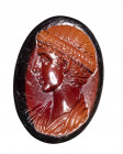 A fine late roman garnet intaglio. Female bust.