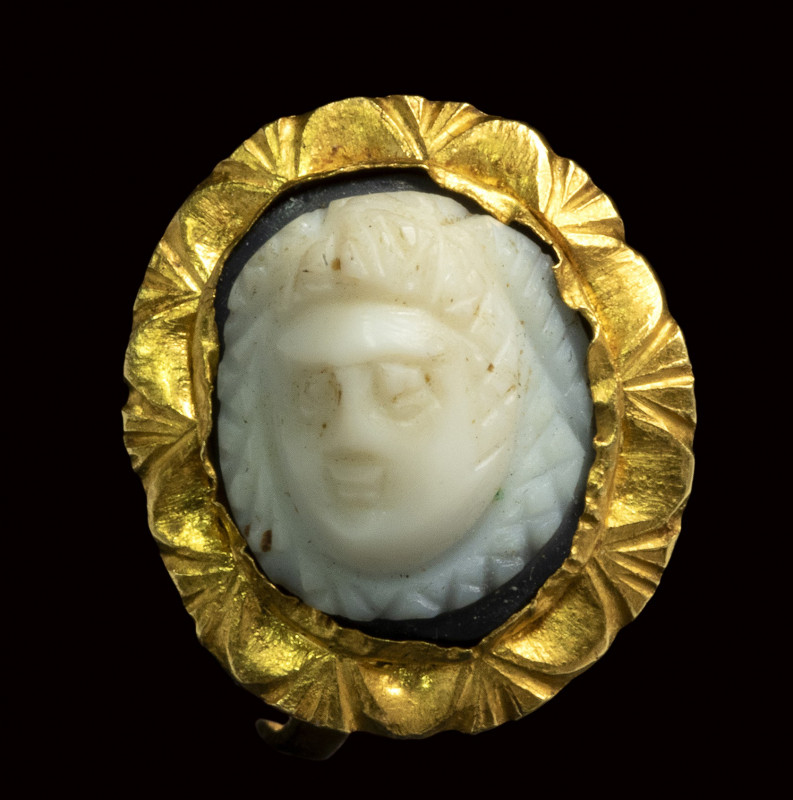 A roman onyx cameo set in a gold ring. Frontal mask of Medusa. 

3rd century A...