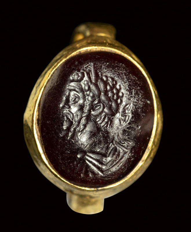 A roman garnet intaglio set in a gold ring. Bust of Septimius Severus. 

2nd c...