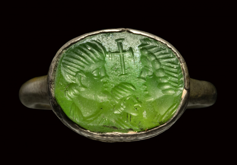 A Late Roman - Early Christian green glass intaglio, set in a silver ring. Busts...