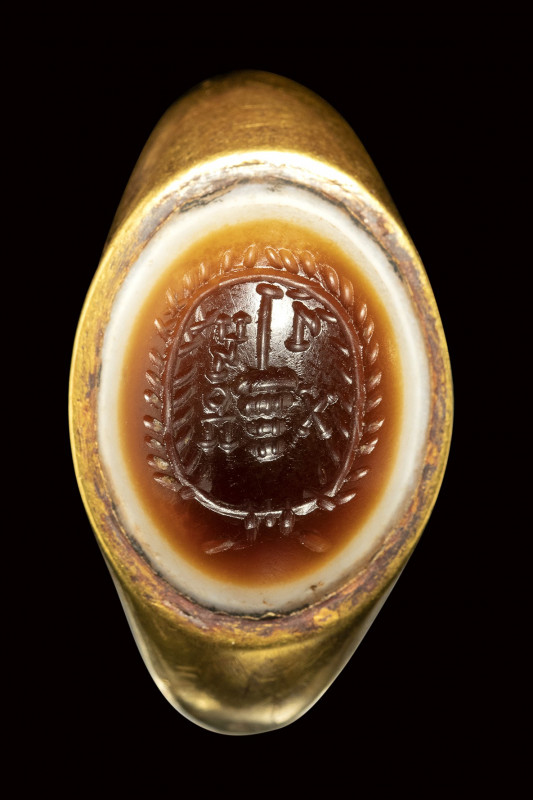 A large banded agate intaglio set in a Sabean gold ring. Emblema with letters.
...