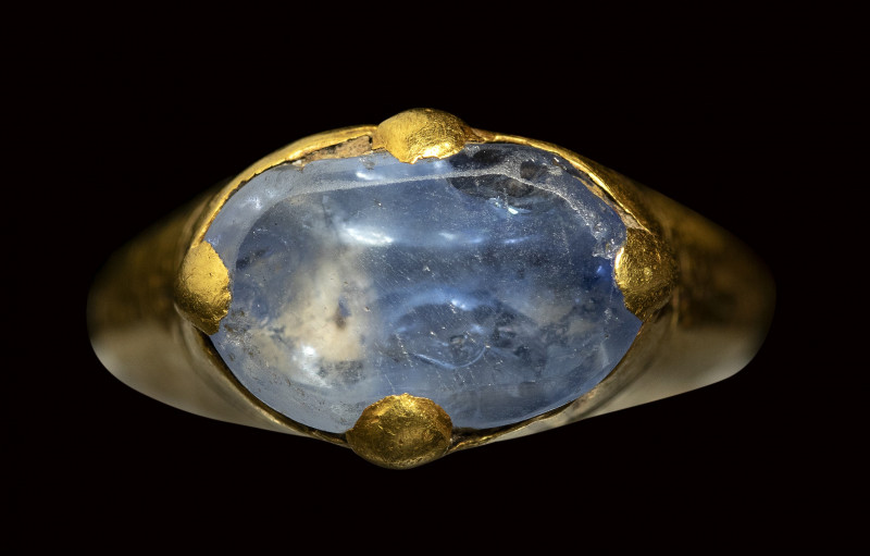 An islamic gold ring set with a large blue sapphire. 

12th century A.D.

St...