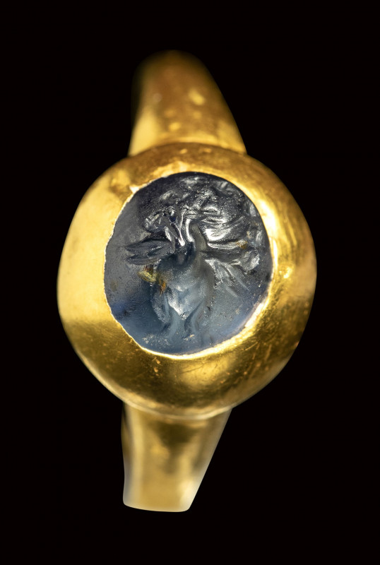 A late roman blue sapphire intaglio set in a gold ring. Peacock. 

4th century...