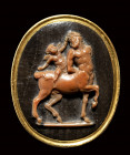 An important signed agate cameo set in a gold ring. Centaur with Cupid