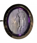 A fine amethyst neoclassical intaglio set in a gold brooch. Apollo playing lyra.
