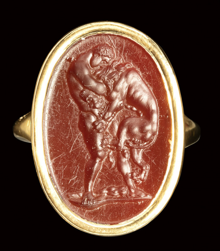 A fine neoclassical carnelian intaglio set in a modern gold ring. Hercules fight...