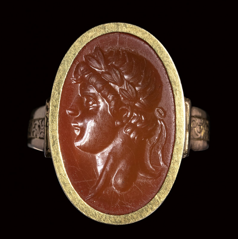 A postclassical carnelian intaglio set in a gold ring. Portrait of an emperor. ...