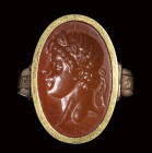 A postclassical carnelian intaglio set in a gold ring. Portrait of an emperor.