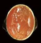 A  carnelian intaglio set in a gold ring. Male portrait.
