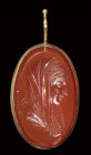 A neoclassical carnelian intaglio set in a gold devotional pendant. Madonna with emblema.