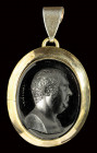 A dark glass impression, set in a gold pendant. Portrait of Henry Fox signed Marchant.