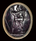 A dark purple glass impression set in gilted metal fob seal.  Hermaprodite and Salmace.