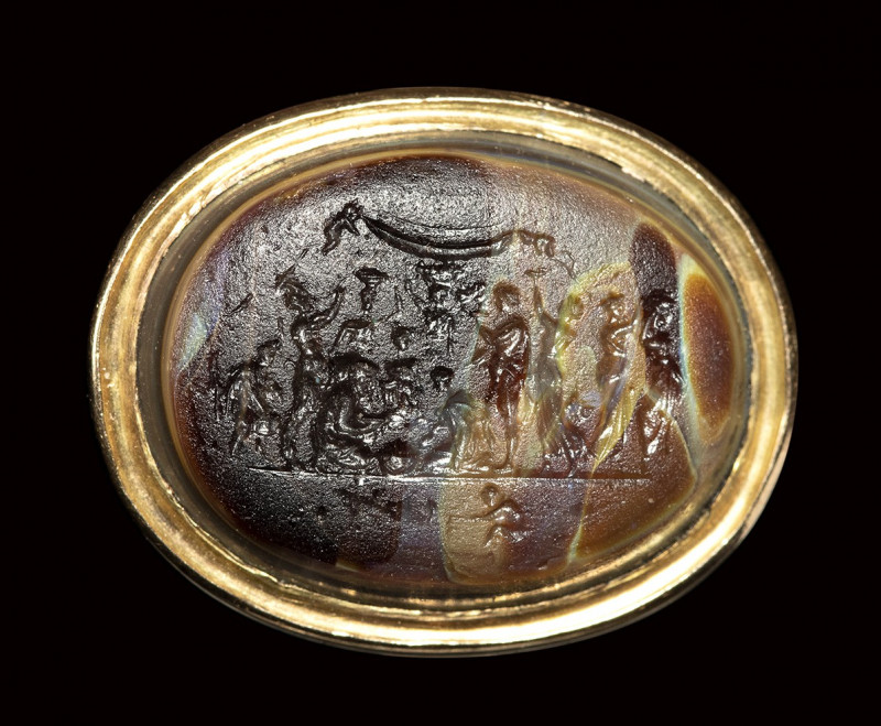 A polychrome glass paste impression set in a gold ring. The "Michelangelo seal"....