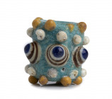 PHOENICIAN GLASS PASTE BEAD
4th - 3rd centuries BC
height cm 3,2

Rod-formed glass bead decorated with eyes each with translucent dark blue pupils and...