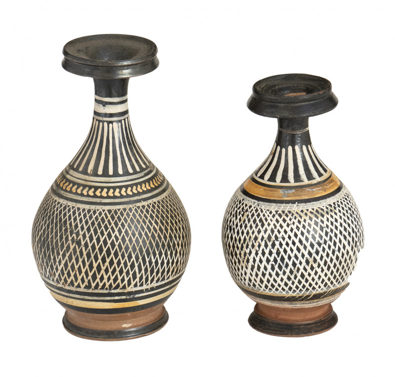 COUPLE OF APULIAN GNATHIA-WARE 'NET' BOTTLES
Late 4th century BC
height max cm 1...