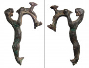 A Roman bronze handle for a vessel in the form of a panther, ca. 1st - 3rd Century A.D. , likely for an olpe, the panther depicted with from paws gras...
