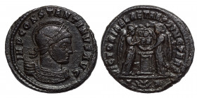 Constantine I, 307/310-337. Follis (bronze, 2.88 g, 19 mm). Arelate, struck 319. Laureate, helmeted and cuirassed bust right. Rev. Two Victories facin...