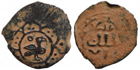 ISLAMIC. Uncertain civic issue (?). Fals (bronze, 1.21 g, 18 mm). Bird to right, within ornamental design. Rev. Arabic legend. Very fine.