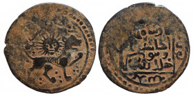 ISLAMIC. Īlkhānids, Fals (bronze, 1.64 g, 20 mm ). Lion right, rising sun behind. Rev. Arabic legend. Very fine.