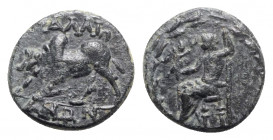 Lydia, Tralleis, 2nd-1st century BC. Æ (15mm, 2.95g, 11h). Zeus seated l., holding nike and long sceptre; all within wreath. R/ Humped bull butting to...