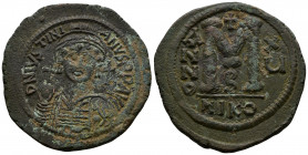 (Bronze, 22.72g 40mm) Justinian I AD 527-565. RY 15 (541/2). Nikomedia Follis AE 
 Helmeted and cuirassed bust facing, holding globus cruciger and shi...