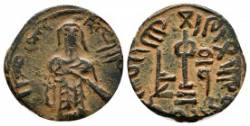 Arab-Byzantine (Standing Caliph) coinage. 'Abd al-Malik ibn Marwan. AH 65-86 / AD 685-705. Æ Fals (18mm, 2.81g). Halab. Caliph standing facing, with l...