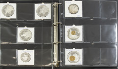 Album with ca. 35 large format european currency etc. medals, many silvered, (partly) gilt or coloured
