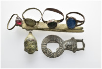 Antiquities Mixed Lot.4 rings a tweezer a mask and a buckle. SOLD AS SEEN NO RETURN.