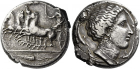 Syracuse 
Tetradrachm circa 405, AR 17.31 g. Fast quadriga driven l. by female charioteer holding reins in l. hand and torch in raised r.; in field a...