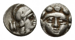 Pisidia, Selge, Obol, 0.4gr, 8.3mm. 350-300 BC Obverse: facing gorgoneion Reverse: head of Athena in corynthian helmet right astragalos to left