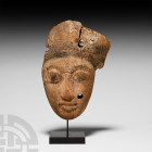 Egyptian Wooden Mummy Mask. Roman Period, 30 B.C.-323 A.D. A carved wood mummy mask with remains of black painted semi-naturalistic facial detailing, ...