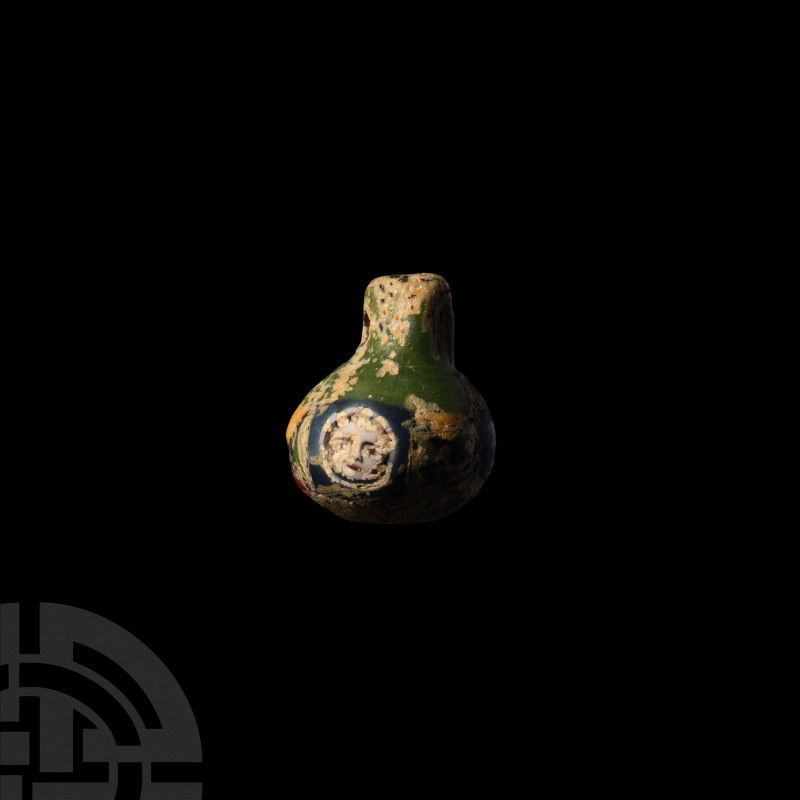 Phoenician Glass Face Bulla. 6th-4th century B.C. A spherical polychrome glass b...