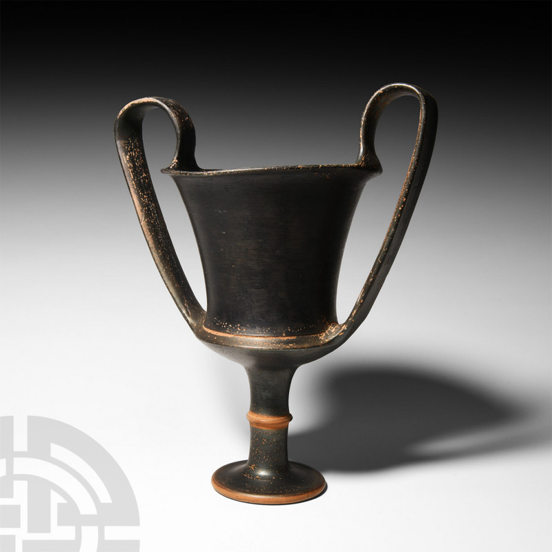 Greek Black Ware Kantharos. 5th-4th century B.C. A black ware kantharos with two...
