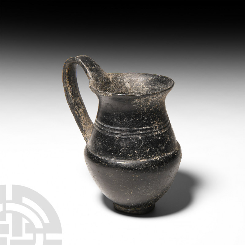 Etruscan Bucchero Olpe. c.625-550 B.C. A voluminous pear-shaped clay bucchero co...