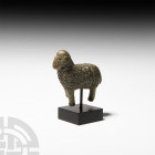 Greek Figure of a Ram. 5th-3rd century B.C. A bronze figure modelled in the round as a standing ram with thick fleece, short tail, tightly curled horn...