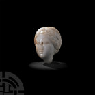 Hellenistic Marble Head of Temis. 2nd-1st century B.C. A marble head modelled in the round as that of the goddess Temis or Ceres, with semi-naturalist...