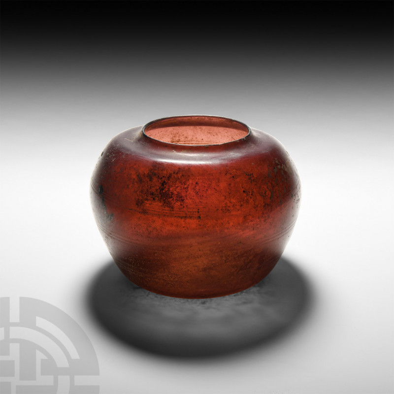 Roman Aubergine Glass Jar. 1st century A.D. An aubergine glass jar with squat, p...