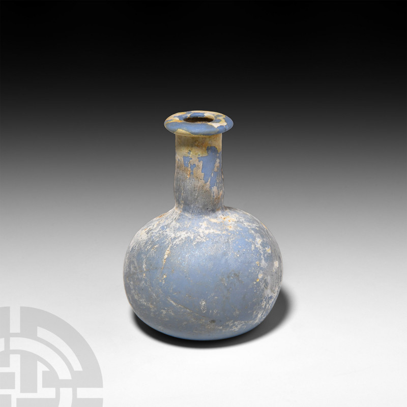 Roman Opaque Blue Glass Flask. 1st century A.D. An opaque milky blue glass flask...