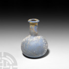 Roman Opaque Blue Glass Flask. 1st century A.D. An opaque milky blue glass flask with bulbous body, cylindrical neck and everted rim. 24.9 grams, 65 m...